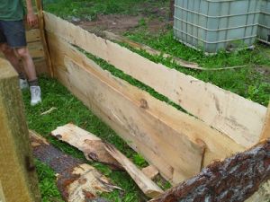 Raised bed under construction (note wood slabs added to inside to cover gaps).jpg